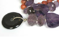 7951: Beaded orange multi-stone  donut necklaces